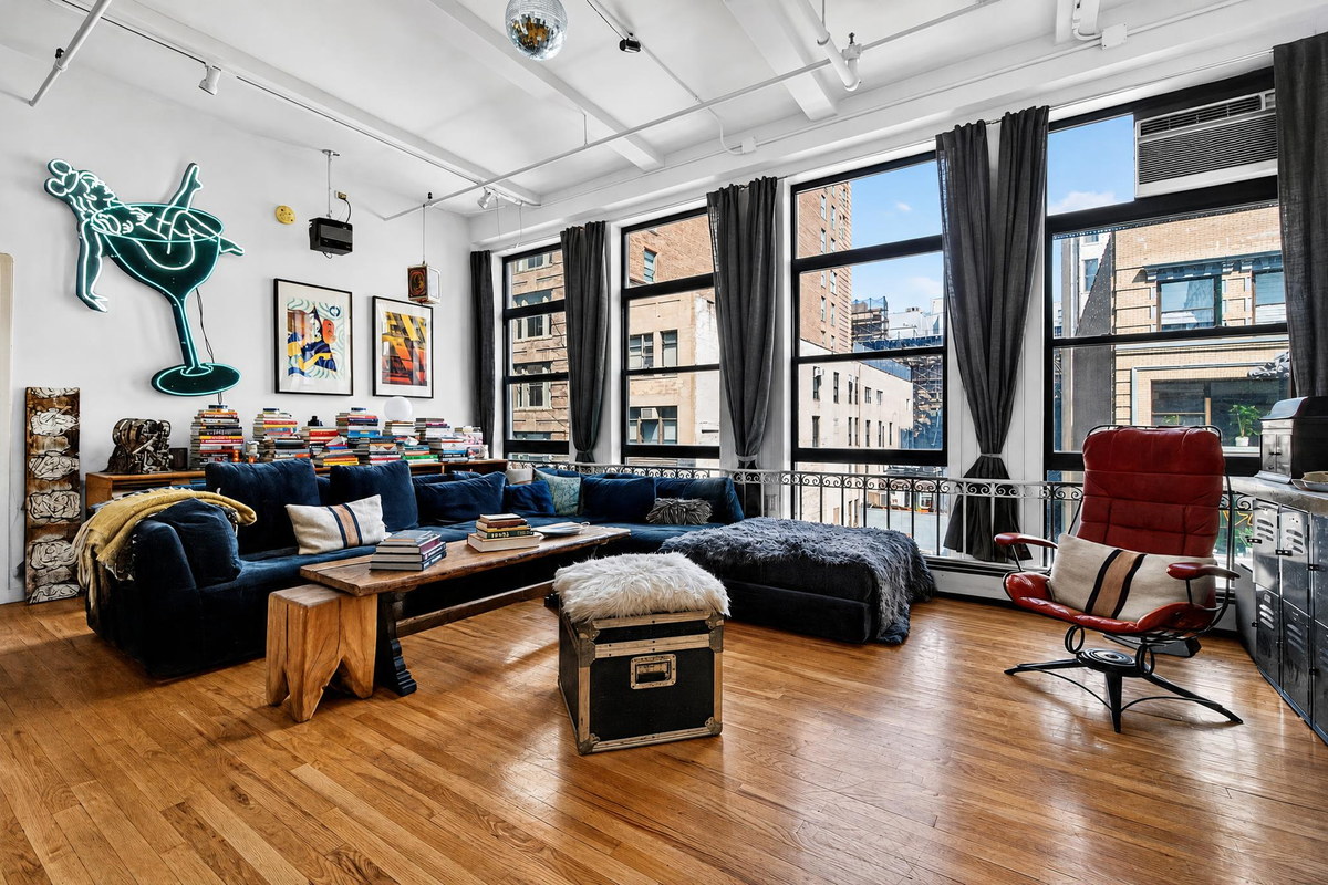 Chelsea artist loft with neon sign, disco ball, and wall of books