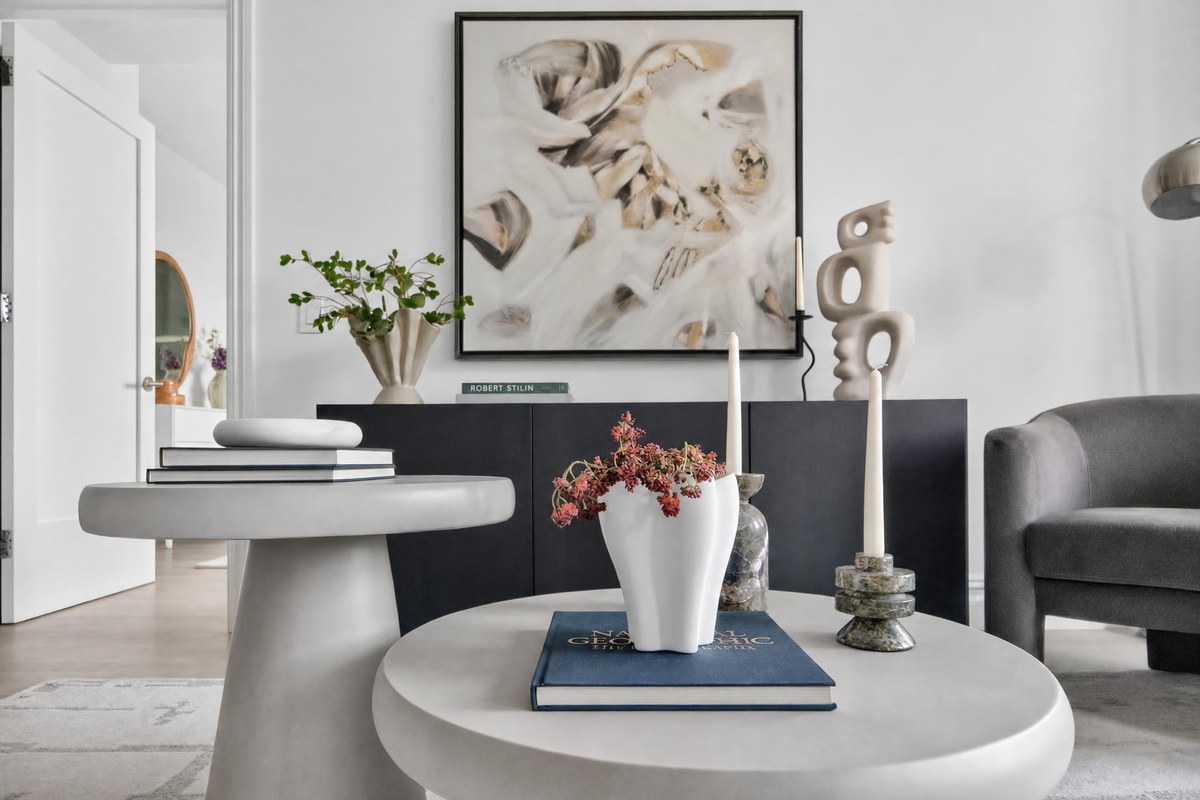 Styled interior vignette with sculptural vase and abstract art